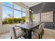 Modern dining room with a large window overlooking the backyard and a wood table that seats six at 37654 N 102Nd Pl, Scottsdale, AZ 85262