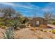 Attractive exterior featuring gravel landscaping, native plants, and a desert aesthetic at 37654 N 102Nd Pl, Scottsdale, AZ 85262