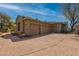 Charming exterior with a three-car garage and mature desert landscaping at 37654 N 102Nd Pl, Scottsdale, AZ 85262