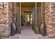 Stunning stone accents, large entry door, and decorative metal art pieces highlight this property's entry at 37654 N 102Nd Pl, Scottsdale, AZ 85262