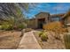 Beautiful desert landscaping and walkway leading up to the entrance of this charming home at 37654 N 102Nd Pl, Scottsdale, AZ 85262