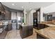 Spacious kitchen featuring dark wood cabinetry, stainless steel appliances, and granite countertops with a center island at 37654 N 102Nd Pl, Scottsdale, AZ 85262