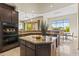 Kitchen features dark wood cabinets, granite countertops, stainless steel appliances and a view to the dining room at 37654 N 102Nd Pl, Scottsdale, AZ 85262