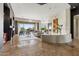 Open-concept living room featuring travertine flooring, elegant lighting, and backyard views at 37654 N 102Nd Pl, Scottsdale, AZ 85262