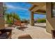 Inviting covered patio with comfortable seating and views of the desert landscape at 37654 N 102Nd Pl, Scottsdale, AZ 85262