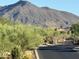 Gated street with lush landscaping and mountain views create an inviting desert community at 37654 N 102Nd Pl, Scottsdale, AZ 85262