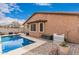 Lovely backyard featuring a pool, patio, and desert landscaping, creating a private outdoor retreat at 38062 W San Capistrano Ave, Maricopa, AZ 85138