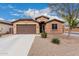 Charming single-story home with a two-car garage and low-maintenance desert landscaping at 38062 W San Capistrano Ave, Maricopa, AZ 85138