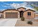 Charming single-story home with a two-car garage and low-maintenance desert landscaping at 38062 W San Capistrano Ave, Maricopa, AZ 85138