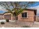 Single-story home featuring a two-car garage and low-maintenance desert landscaping at 38062 W San Capistrano Ave, Maricopa, AZ 85138