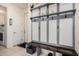 Well-organized mudroom with coat hooks, shelves, and a bench, offering practical storage solutions at 38062 W San Capistrano Ave, Maricopa, AZ 85138