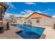 Sparkling backyard pool with a tiled water feature set in a private, walled yard, perfect for relaxation and recreation at 38062 W San Capistrano Ave, Maricopa, AZ 85138