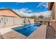 Inviting swimming pool in a private backyard setting, framed by a paved patio and mature landscaping at 38062 W San Capistrano Ave, Maricopa, AZ 85138