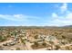 Expansive aerial view of desert community homes, mountains, and bright blue skies at 38413 N 16Th St, Phoenix, AZ 85086