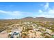 Desert community with mountain views, homes, RVs, desert trees, and bright blue skies at 38413 N 16Th St, Phoenix, AZ 85086