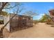 Backyard view of a large outdoor aviary, showcasing the property's unique amenity for bird enthusiasts at 38413 N 16Th St, Phoenix, AZ 85086