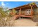 Backyard deck with a covered porch, outdoor seating, and landscaped surroundings at 38413 N 16Th St, Phoenix, AZ 85086