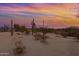 Desert backyard at sunset with fire pit, cactus, and desert trees at 38413 N 16Th St, Phoenix, AZ 85086