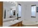 Bright bathroom featuring a vanity, large mirror, and picture frame windows at 38413 N 16Th St, Phoenix, AZ 85086