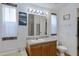 Bright bathroom featuring a vanity, large mirror, and picture frame windows at 38413 N 16Th St, Phoenix, AZ 85086