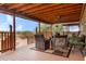 Spacious covered porch with outdoor seating, ceiling fan, and scenic views at 38413 N 16Th St, Phoenix, AZ 85086