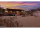 Exterior of a home at sunset, showcasing the covered porch and landscaping at 38413 N 16Th St, Phoenix, AZ 85086