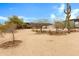 Spacious gravel lot with desert plants and single story home with additional storage shed and RV parking at 38413 N 16Th St, Phoenix, AZ 85086