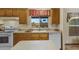 Well-lit kitchen featuring wood cabinets, light countertops, and essential appliances at 38413 N 16Th St, Phoenix, AZ 85086