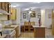 Cozy kitchen featuring wood cabinets, light countertops, and a dining area with rustic wooden chairs at 38413 N 16Th St, Phoenix, AZ 85086