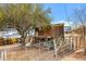 Exterior view of a shed with rustic wooden details, showing storage and utility on a desert property at 38413 N 16Th St, Phoenix, AZ 85086