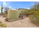 Exterior shot of large water tanks near the home, showing water storage capacity in a desert landscape setting at 38413 N 16Th St, Phoenix, AZ 85086