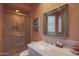 Bathroom featuring vanity, framed mirror, and tiled walk-in shower with glass door at 40262 N 107Th Pl, Scottsdale, AZ 85262