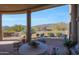 Relaxing covered patio with comfortable seating and decor, overlooking serene desert landscape at 40262 N 107Th Pl, Scottsdale, AZ 85262