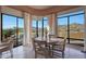 Charming dining area with large windows offering breathtaking views of the surrounding landscape at 40262 N 107Th Pl, Scottsdale, AZ 85262