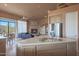 Bright kitchen and living space with island cooktop and fireplace, perfect for entertaining at 40262 N 107Th Pl, Scottsdale, AZ 85262