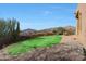 Backyard putting green with desert landscaping and scenic mountain views for the avid golfer's enjoyment at 40262 N 107Th Pl, Scottsdale, AZ 85262