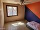 Bedroom features a ceiling fan, a large window, and modern tile flooring at 4101 E Nancy Ln, Phoenix, AZ 85042