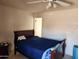 Bedroom features a ceiling fan and a bed with a dark wood frame and blue comforter at 4101 E Nancy Ln, Phoenix, AZ 85042