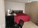 Bedroom with ceiling fan, tile floors and a red bedspread at 4101 E Nancy Ln, Phoenix, AZ 85042