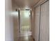 Hallway featuring neutral paint, a tiled floor, and multiple white doors at 4101 E Nancy Ln, Phoenix, AZ 85042