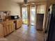 Functional kitchen with wooden cabinets, black appliances, and durable tiled countertops at 4101 E Nancy Ln, Phoenix, AZ 85042