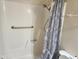 A white shower tub features chrome shower head, grab bar and patterned shower curtain at 4101 E Nancy Ln, Phoenix, AZ 85042