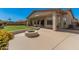 Backyard area featuring a fire pit, covered patio, and green lawn, perfect for gatherings at 4109 E Del Rio St, Gilbert, AZ 85295