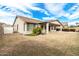 View of home's backyard and covered patio from the grass at 4109 E Del Rio St, Gilbert, AZ 85295