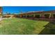 Spacious backyard with a manicured lawn, retaining wall with shrubs and a privacy fence at 4109 E Del Rio St, Gilbert, AZ 85295