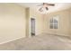 Bedroom with carpet flooring, neutral walls, a ceiling fan, and access to an ensuite bathroom at 4109 E Del Rio St, Gilbert, AZ 85295