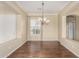 Formal dining area features hardwood floors, chandelier lighting, and natural light from a window at 4109 E Del Rio St, Gilbert, AZ 85295