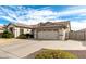 View of the home's exterior, showcasing a spacious driveway and a two-car garage in a well-kept neighborhood at 4109 E Del Rio St, Gilbert, AZ 85295