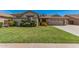 Charming home featuring a lush green lawn and manicured landscaping, creating a welcoming curb appeal at 4109 E Del Rio St, Gilbert, AZ 85295