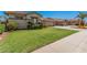 Well-kept front yard with green grass and decorative shrubbery enhancing the home's exterior at 4109 E Del Rio St, Gilbert, AZ 85295
